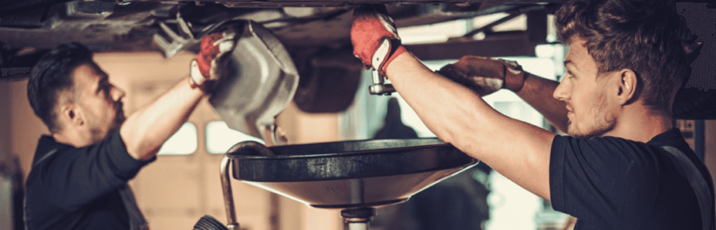 Mechanics changing oil at auto service center in Albany, GA. 