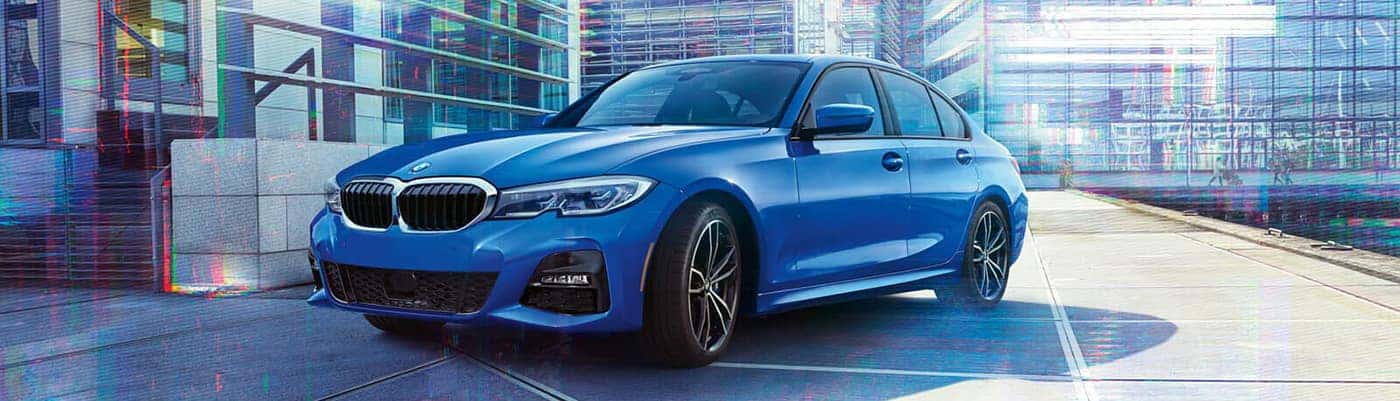 bmw 3 series blue parked on a street