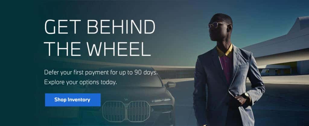 Man next to BMW vehicle.