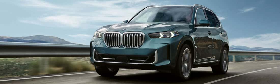 2026 BMW X5 Luxury SUV Driving Down the Road