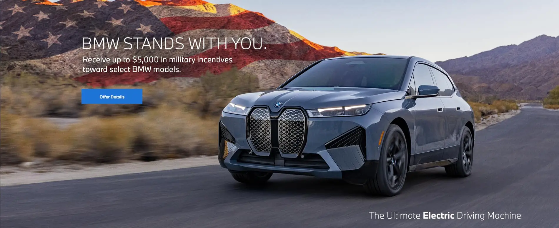 BMW iX driving on a desert road