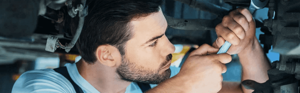 Service Center Technician Working On Vehicle