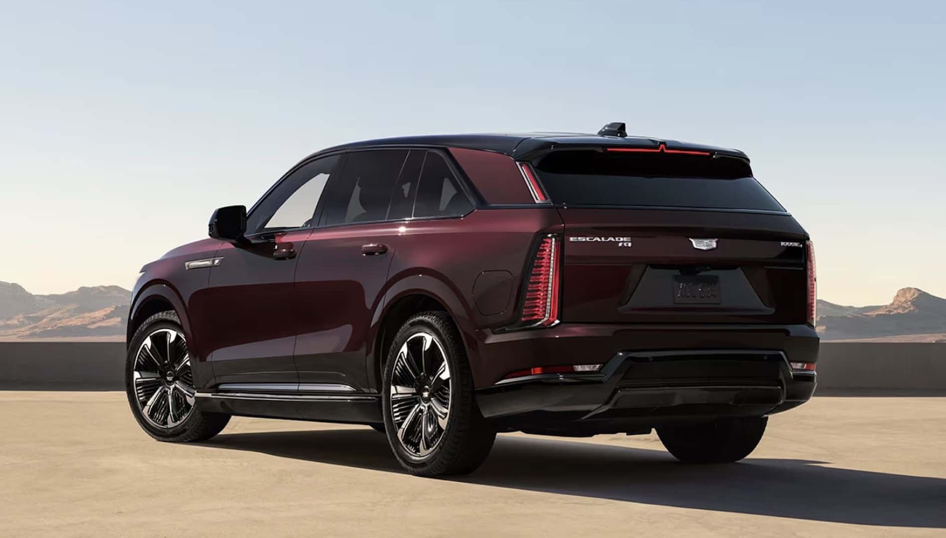 2026 Cadillac Escalade IQ Premium Rear Design with Executive in Suit Walking for sale at Covert Cadillac, Austin, Texas