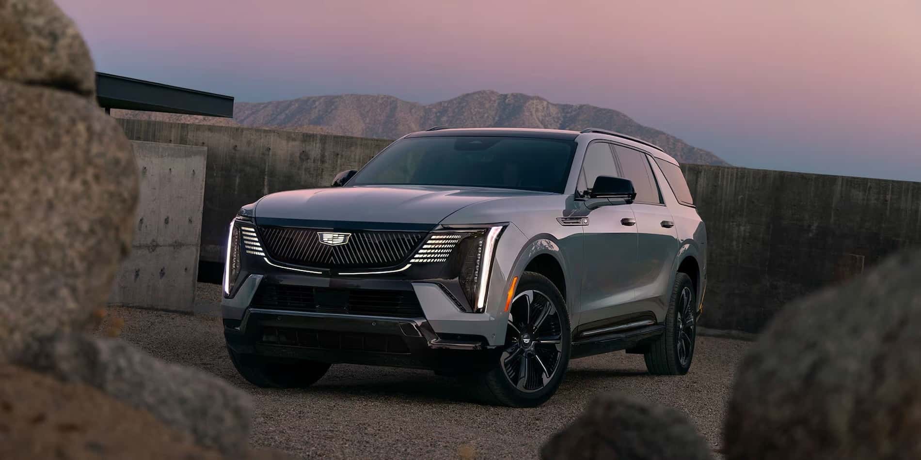 2026 Cadillac Escalade IQL Dramatic Front Three-Quarter View at Sunset with Mountains for sale at Covert Cadillac, Austin, Texas