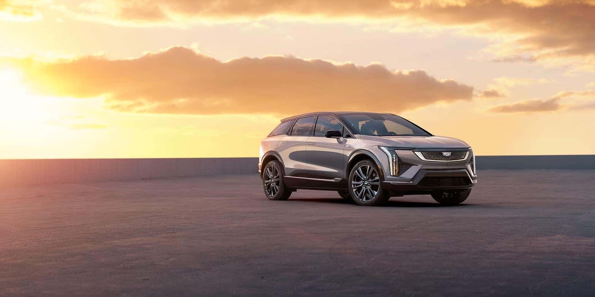2027 Cadillac OPTIQ in silver, front passenger-side view at sunset, at Covert Cadillac Bee Cave in Austin