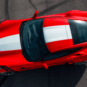 looking down at a parked red and white Corvette Z06