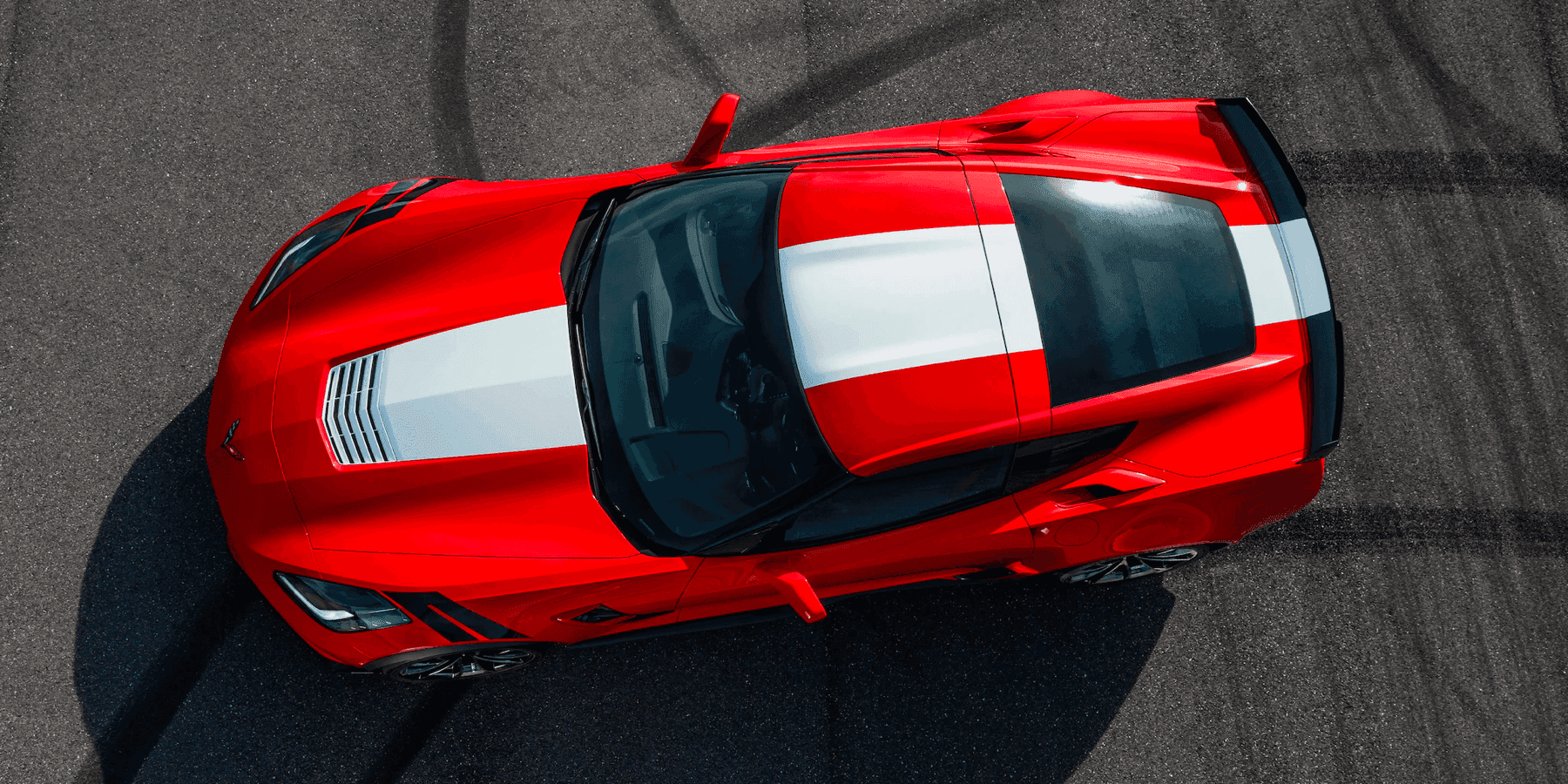 looking down at a parked red and white Corvette Z06
