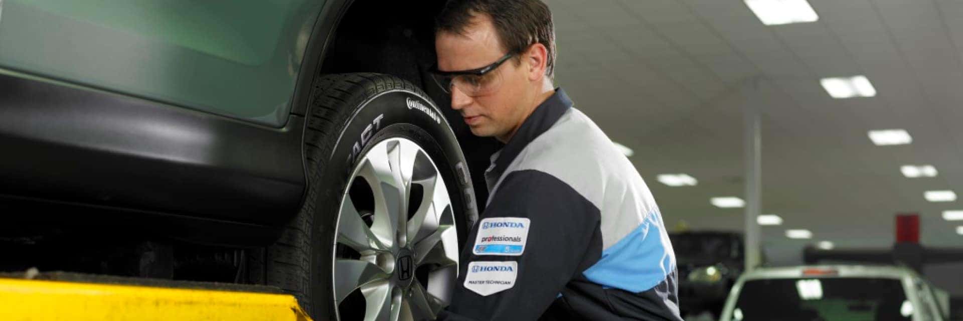 service technician working on tire