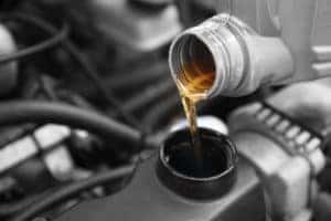 A close up of oil being poured into a vehicle during an oil change at Ira Lexus of Danvers.