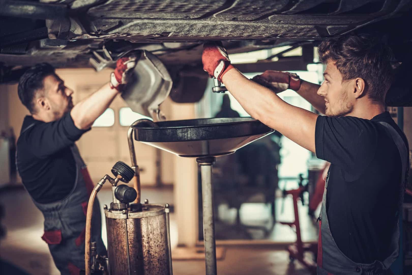 Two of our Lexus service professionals performing an oil change at our dealer near Malden MA.