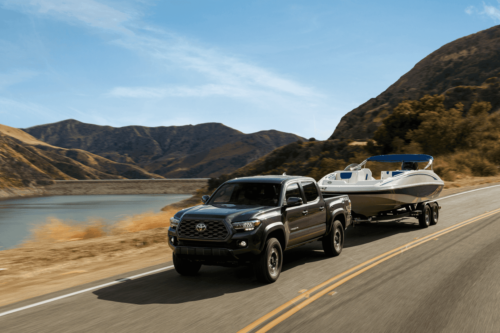 Chevy Silverado vs Toyota Tacoma 2021 Toyota Tacoma TRD Black Towing Boat Lake