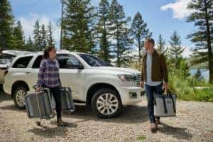 Couple unloading suitcases from 2022 Toyota Sequoia