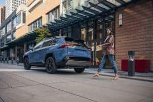 Woman walking to her 2022 Toyota RAV4 