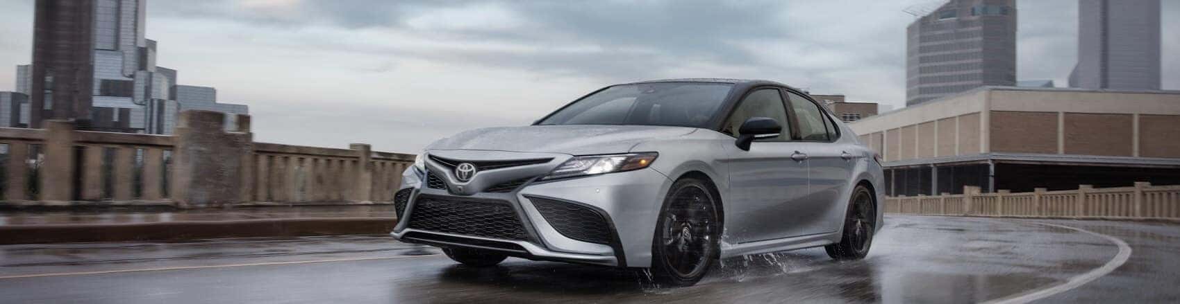 Toyota Camry driving on wet road