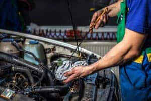 Technician checking oil levels