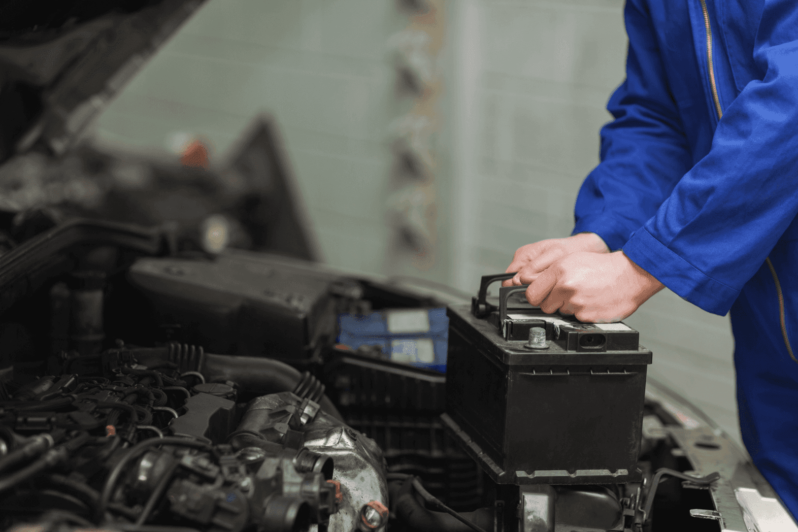 Technician holding Car Battery