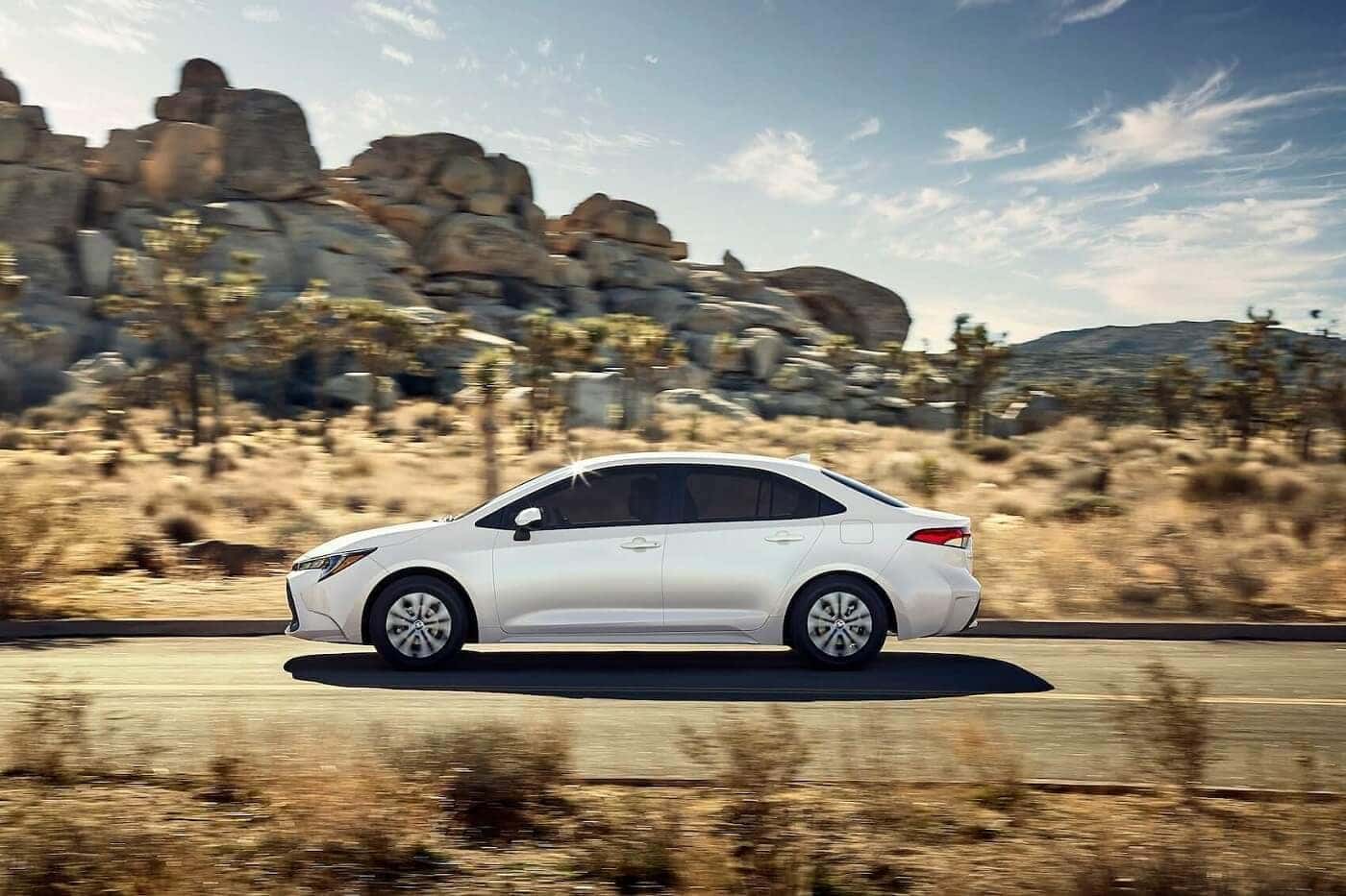 2022 Toyota Corolla driving through desert landscape with rock formations
