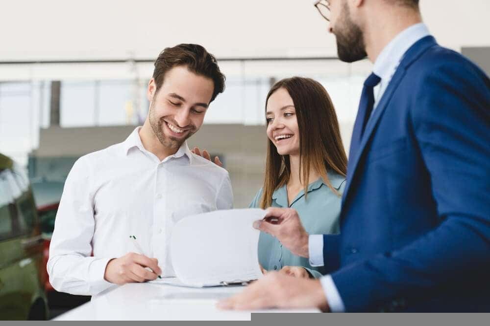 Signing Toyota financing paperwork at the dealership