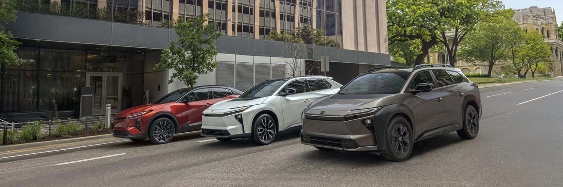 three toyota vehicles in front of city driving