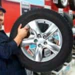 Car mechanic with a tire