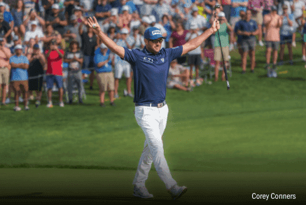 Corry Conner raising hands at golf event