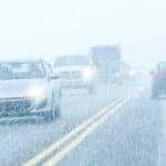 Cars Driving in Snowstorm