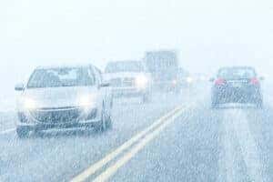 Cars Driving in Snowstorm