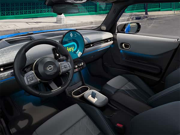 Interior of the 2026 MINI Cooper 2 Door featuring the circular 9.4” OLED display, MINI Toggle Bar, premium seating, and modern cabin design at Patrick MINI.