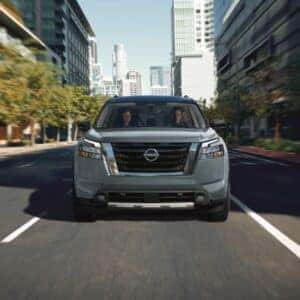 Nissan Pathfinder driving down city street