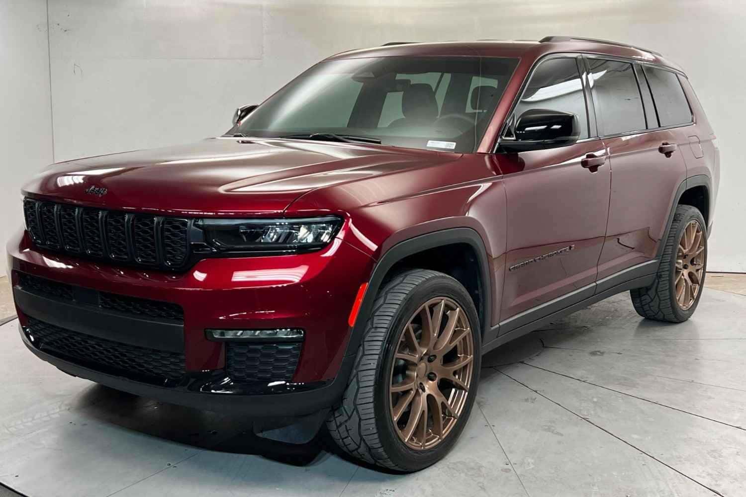 Red Jeep Grand Cherokee front angle at Stephen Wade Nissan showroom in St. George, Utah
