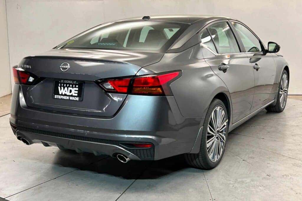 Gray Nissan Altima rear side view at Stephen Wade Nissan showroom in St. George, Utah
