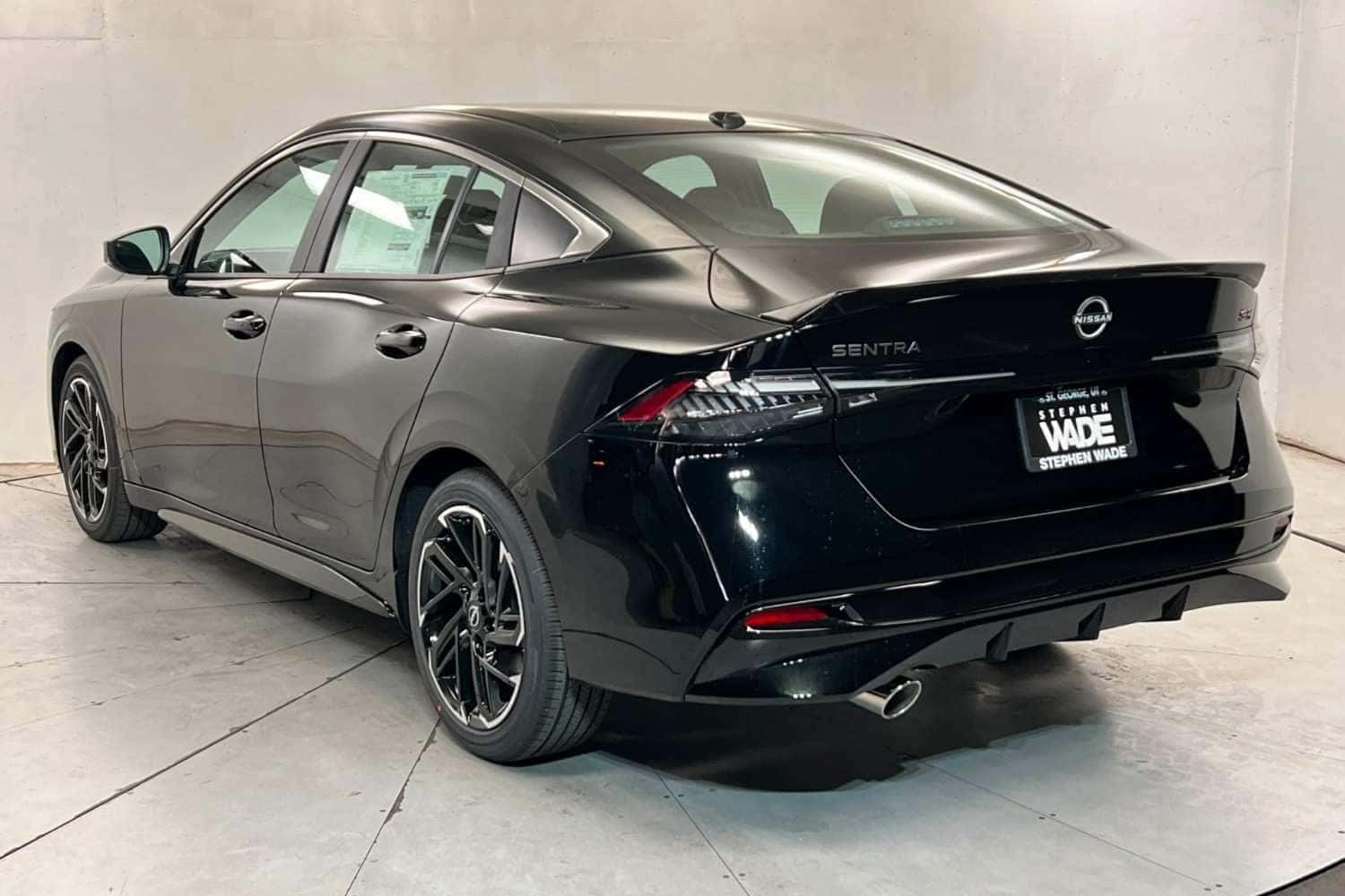 Black Nissan sedan rear view look in showroom at Stephen Wade Nissan in St. George, Utah