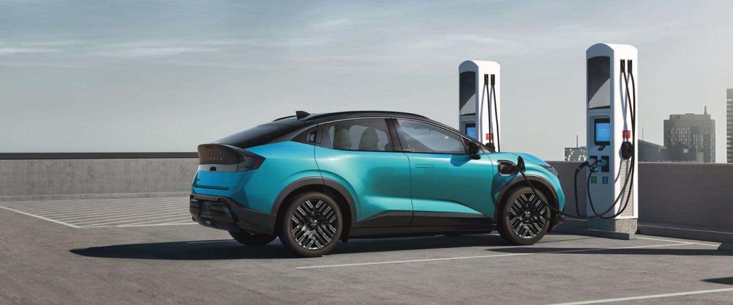 Blue 2026 Nissan Leaf electric vehicle charging at a public station, highlighting EV convenience in St. George, UT