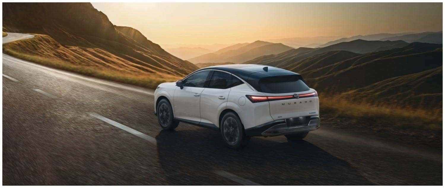 White 2026 Nissan Murano SUV driving on a scenic mountain road, showcasing comfort and performance in St. George, UT
