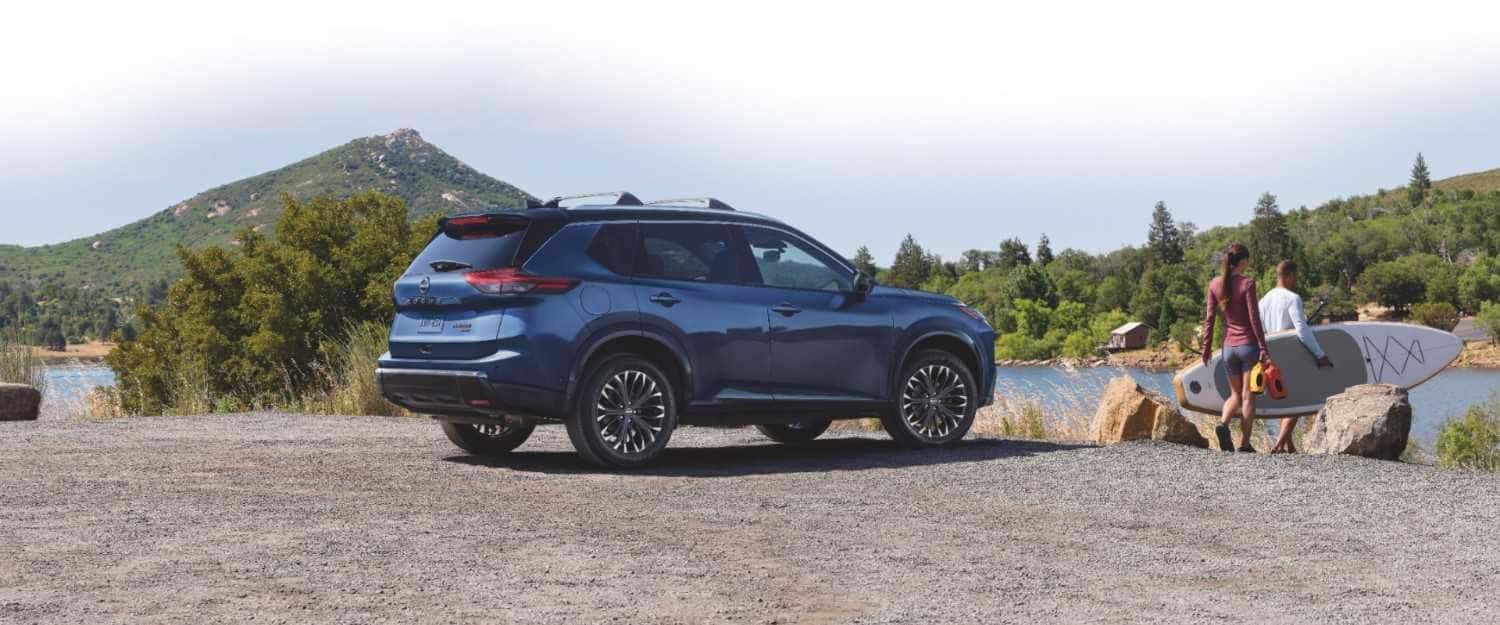 Blue Nissan Rogue SUV parked at an outdoor recreation site, showcasing versatility and comfort in St. George, UT