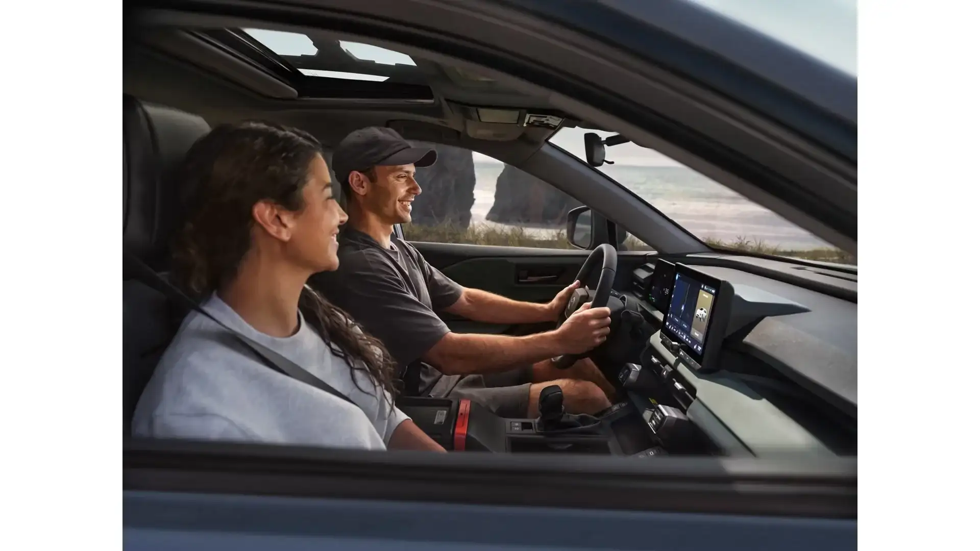 Two people driving a 2026 Toyota RAV4 Plug-in Hybrid Woodland