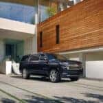 New Chevrolet Suburban Front View in driveway of modern house