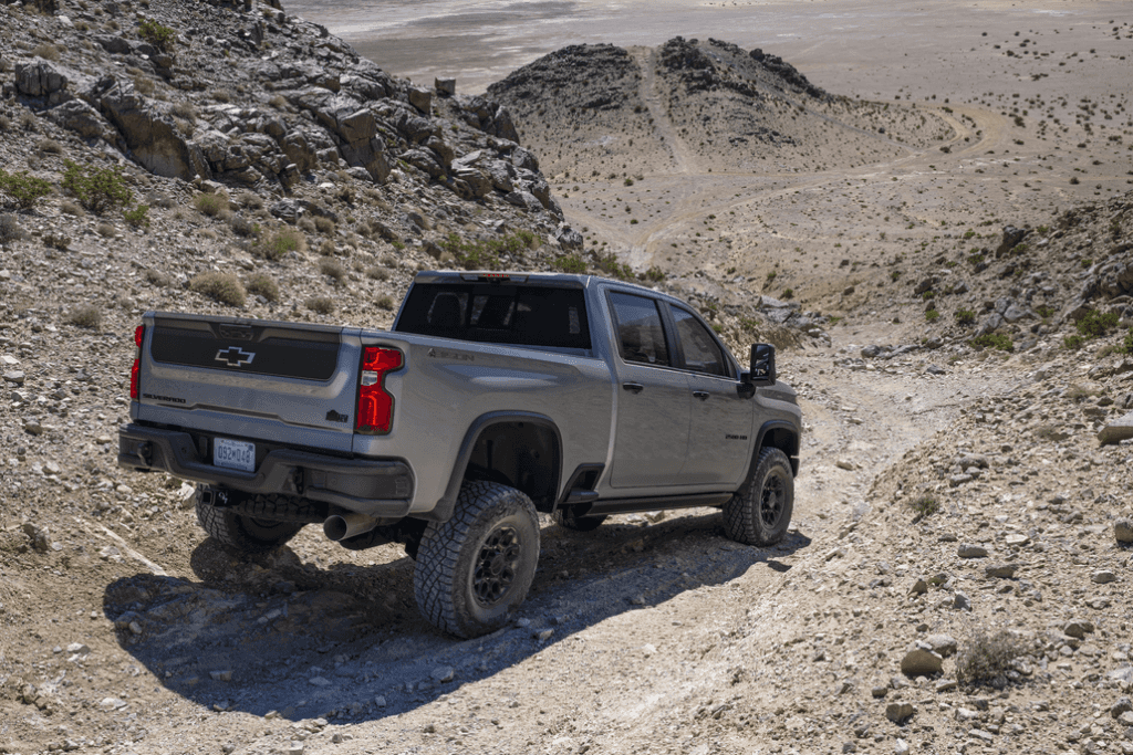 Chevrolet Silverado 2500HD Driving Down a Desert Mountain Rear 3/4 View