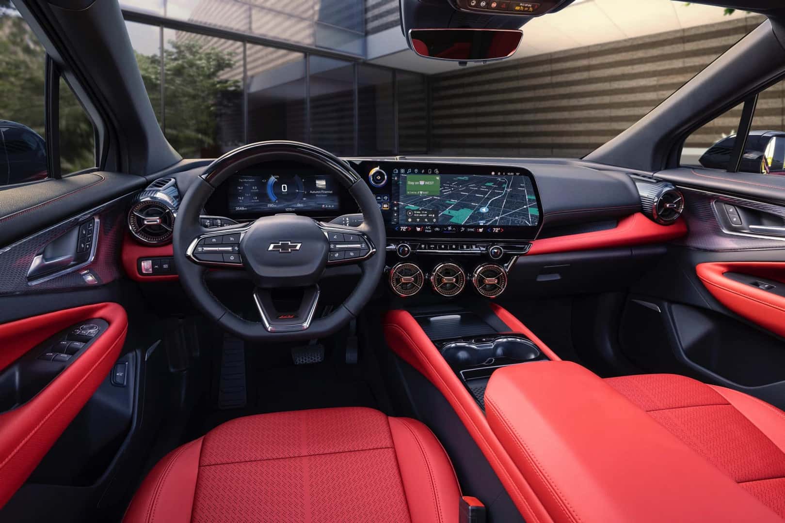 Interior of the Chevy Blazer EV in black and red with view of the cockpit, steering wheel, infotainment, and dash.