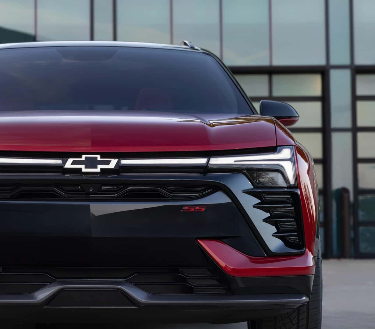 Closeup on the nose, grille, and badging of the 2025 Chevy Blazer EV in red.