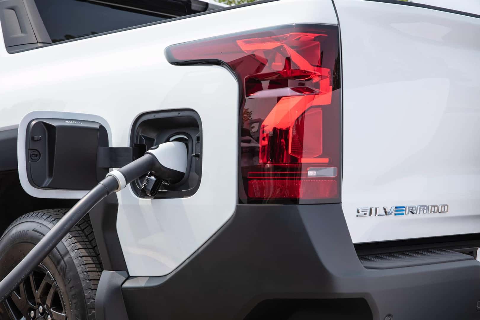 Summit White 2024 Chevrolet Silverado EV charging port