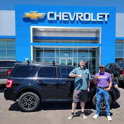 Michael, from Filer, Idaho, with his Black 2010 Ford Escape XLT with Purchase Advisor Gustavo 'Goose' Ceron in front of Twin Falls Chevrolet - the Magic Valley's #1 Chevy Dealer, located in Twin Falls, Idaho.