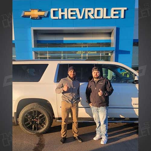 Sam, from Glenns Ferry, Idaho with Purchase Advisor Gustavo 'Goose' Ceron with his White Frost Tricoat 2018 GMC Yukon XL Denali.