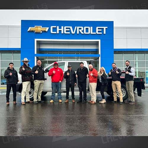 Kolton, from Ontario, Oregon with his flat-bed enhanced, Cummins turbo diesel powered Bright White 2012 Dodge Ram 2500, and Purchase Advisor Gustavo 'Goose' Ceron at Twin Falls Chevy in Twin Falls, Idaho.