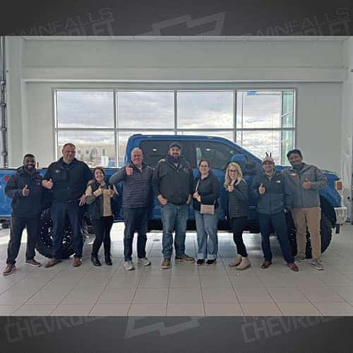 Jeremy, from Grandview, Idaho, with his Velocity Blue 2020 Ford F-250 Lariat with the 6.7L Power Stroke under the hood in the delivery bay at Twin Falls Chevy - assisted by George Hilarides.