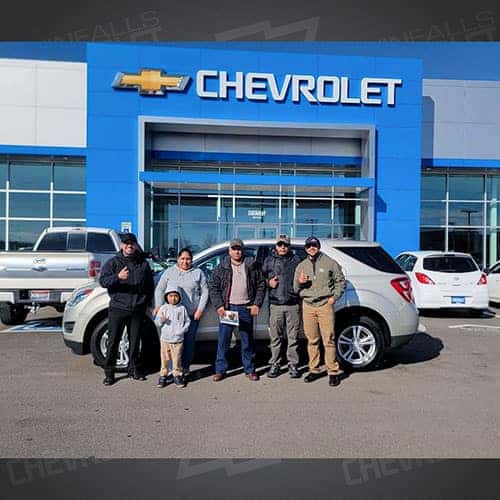 Aurelia, from Jerome, Idaho, with her Champagne Silver Metallic 2016 Chevy Equinox LS, and Purchase Advisor Gustavo 'Goose' Ceron, at Twin Falls, Idaho;'s Twin Falls Chevrolet.