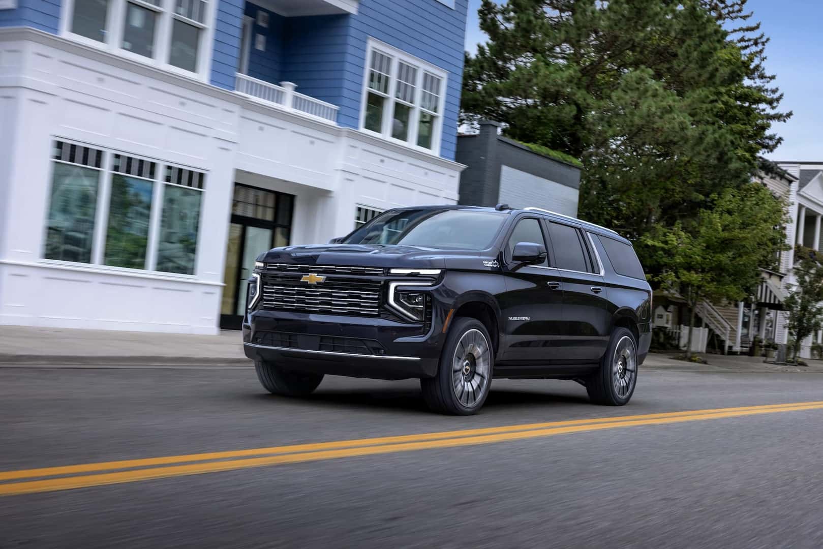 2025 Chevrolet Suburban driving in a town