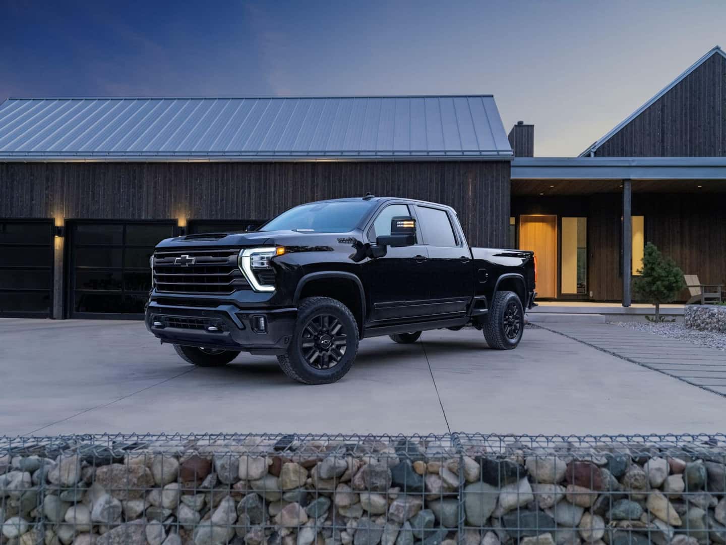 The Robust And Tax-Deduction Qualifying 2024 Chevrolet Silverado 2500 HD High Country, Parked Outside A Hospitable Home