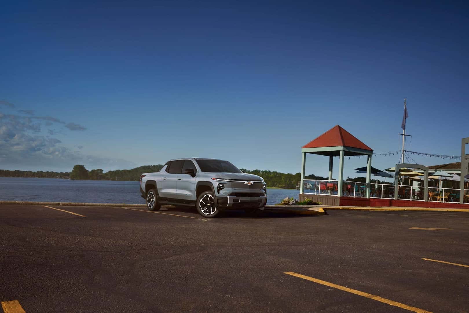 The Efficient And World Record Holder, the 2025 Chevy Silverado, Parked On A Lakeside Parking Lot, Near A Gazebo
