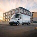 The Dependable And Powerful Chevrolet Brightdrop Driving Past A Business Building